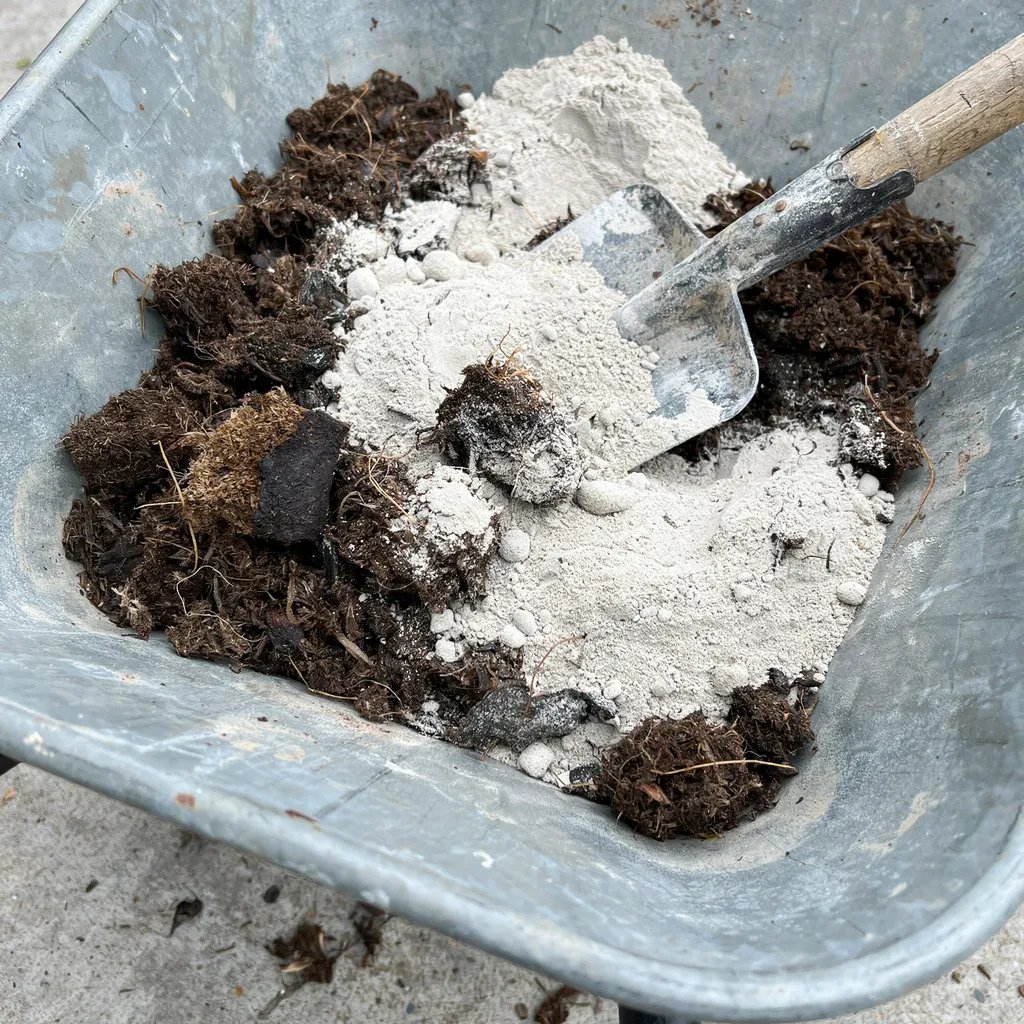 Close-up of peat moss and portland cement being mixed together for hypertufa